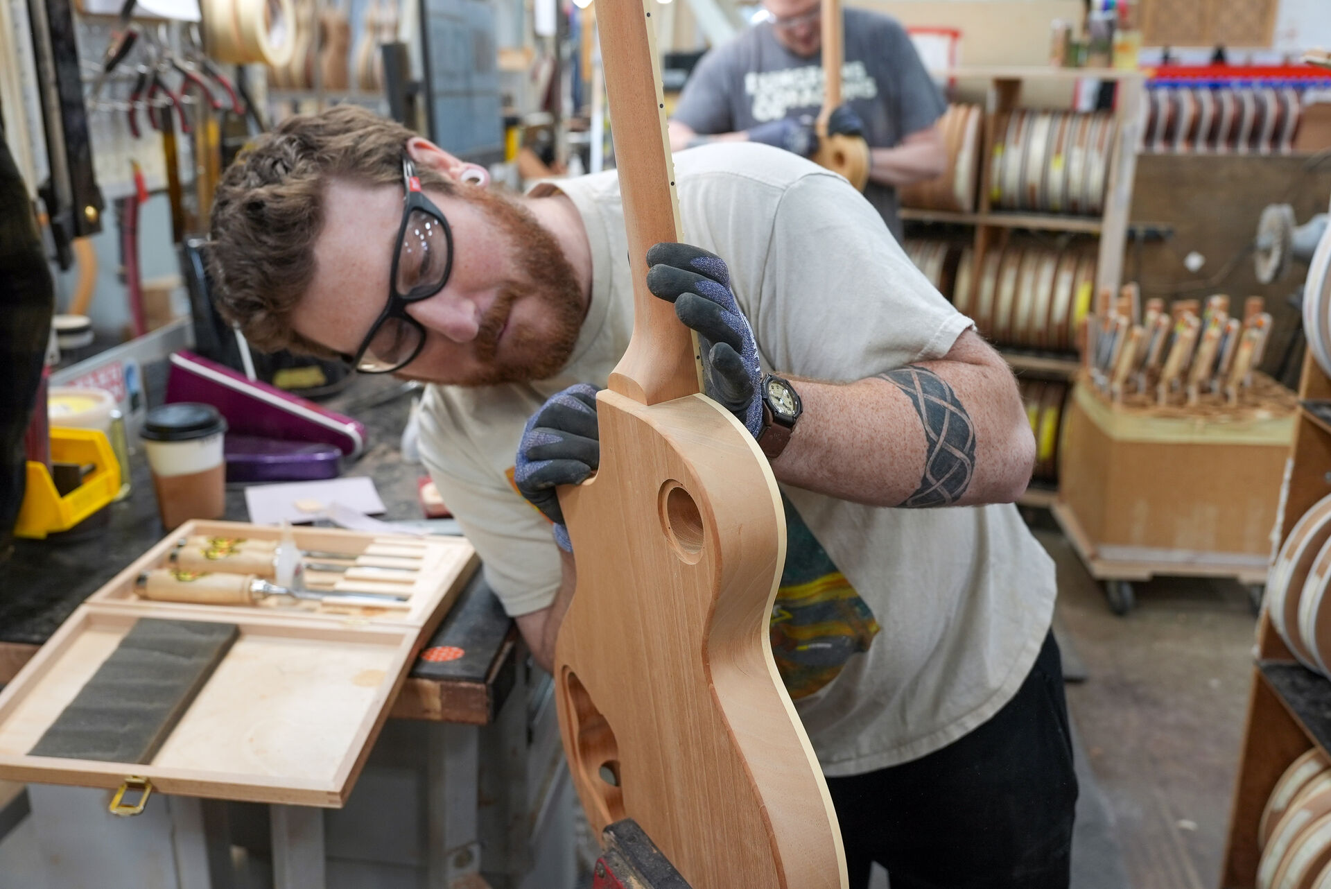 Gibson craftsman examining guitar